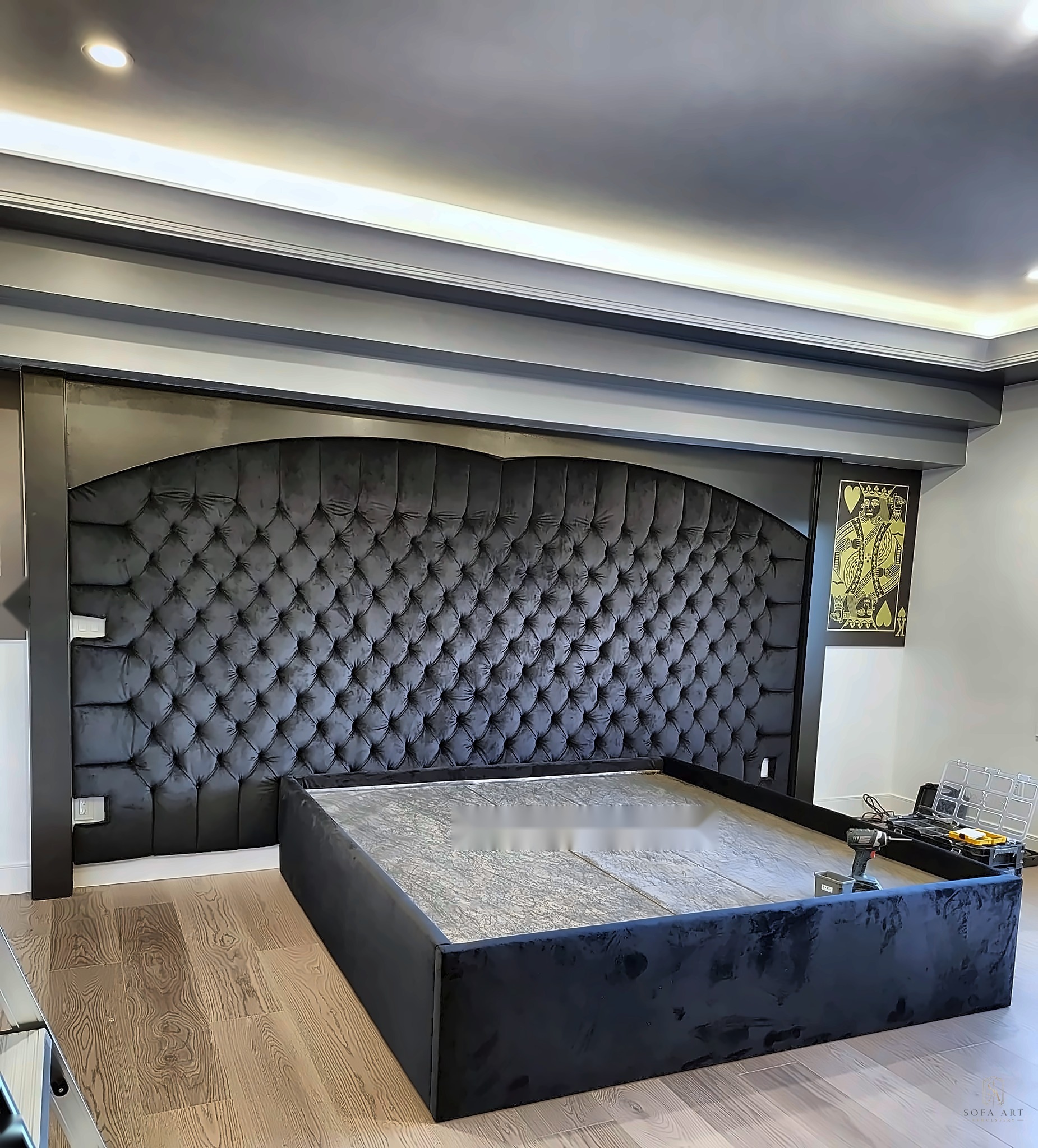 Custom black tufted bed frame and headboard installation — luxury bedroom